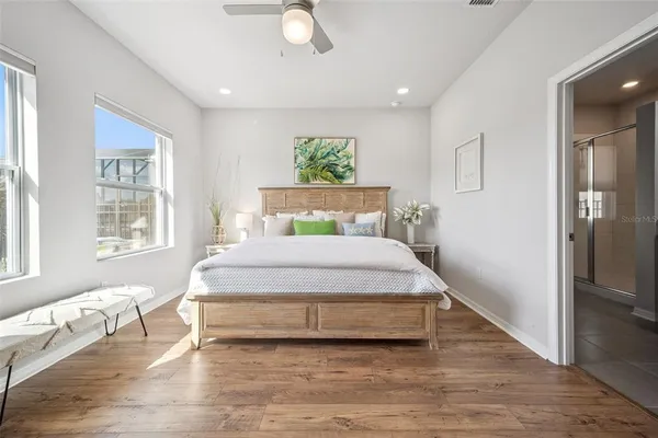 a bedroom with a large bed and a chandelier