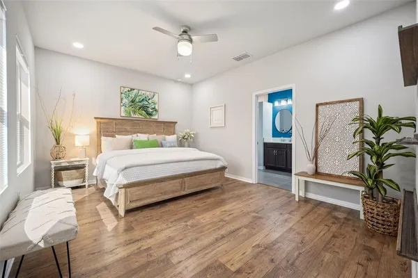 a bedroom with a bed and painting on the wall