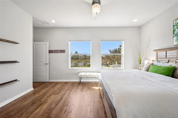 a bathroom with a granite countertop double vanity sink and a mirror