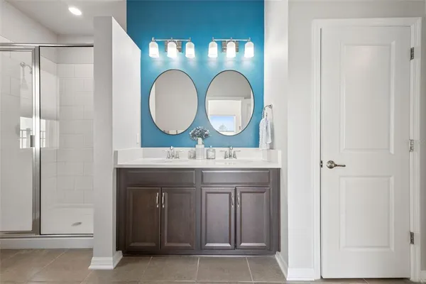 a bathroom with a glass shower door