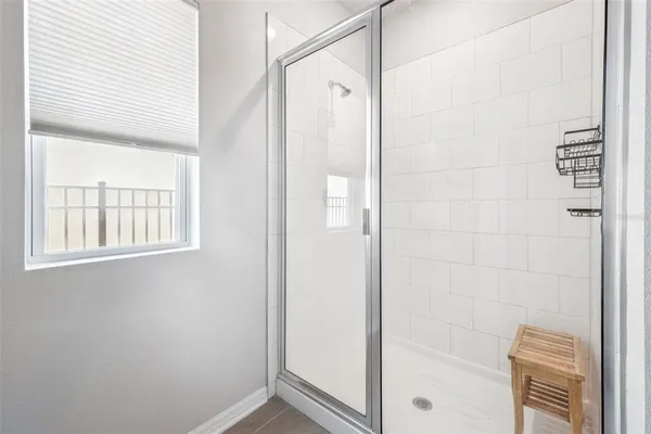 a bedroom that has a bed and a chair in it