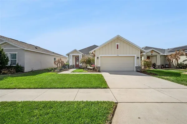 a front view of a house with a yard and garage