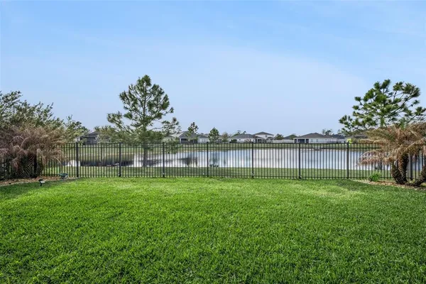 an aerial view of residential houses with outdoor space and parking