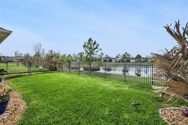 an aerial view of residential houses with outdoor space and swimming pool