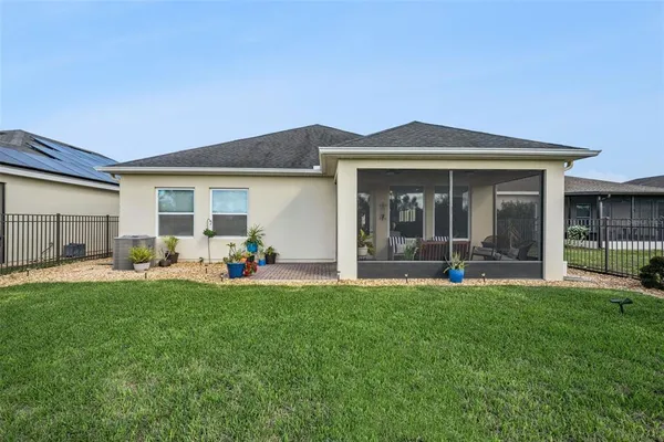 a view of a dining room with furniture and a chandelier