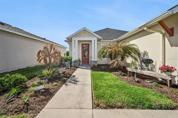 a kitchen with stainless steel appliances a large counter top a stove a chimney a sink and a large window