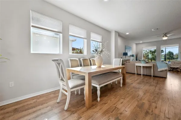 a kitchen with kitchen island wooden cabinets and refrigerator
