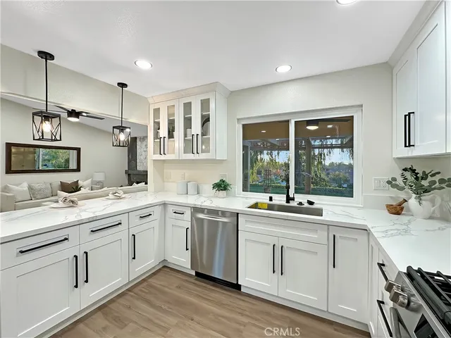 a kitchen with a sink stove and cabinets