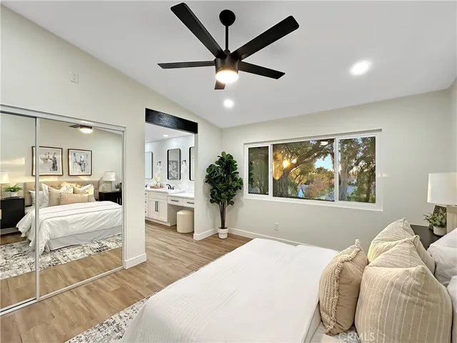 a bedroom with a large bed and a chandelier