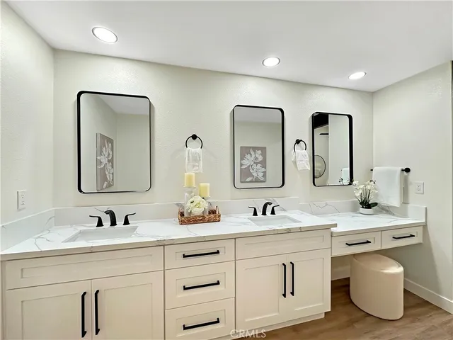 a bathroom with double vanity sinks and a mirror