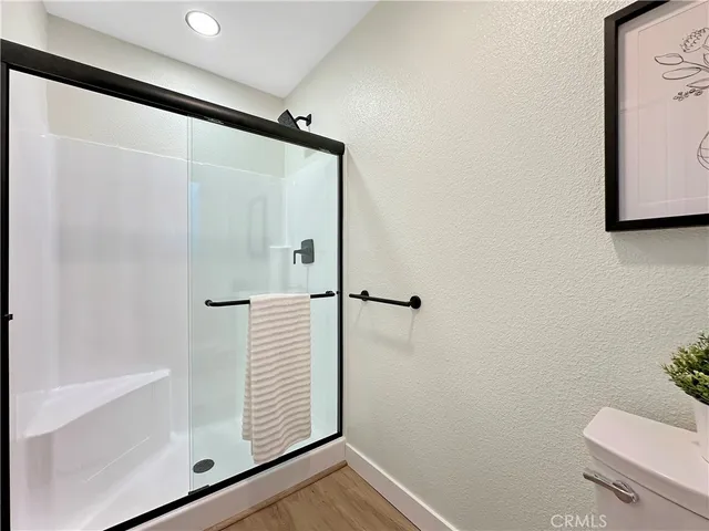 a bathroom with a shower and a toilet