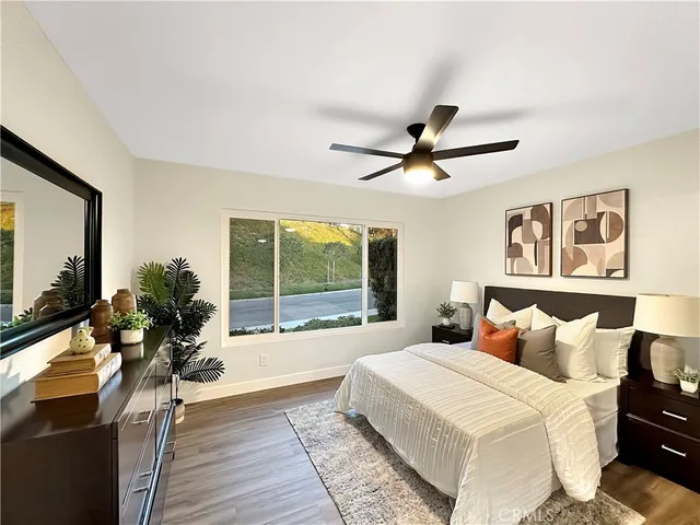 a bedroom with a large bed and a large window