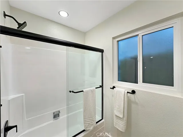 a bathroom with a shower and a mirror