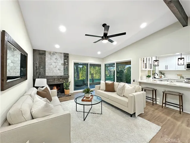 a living room with furniture fireplace and a flat screen tv