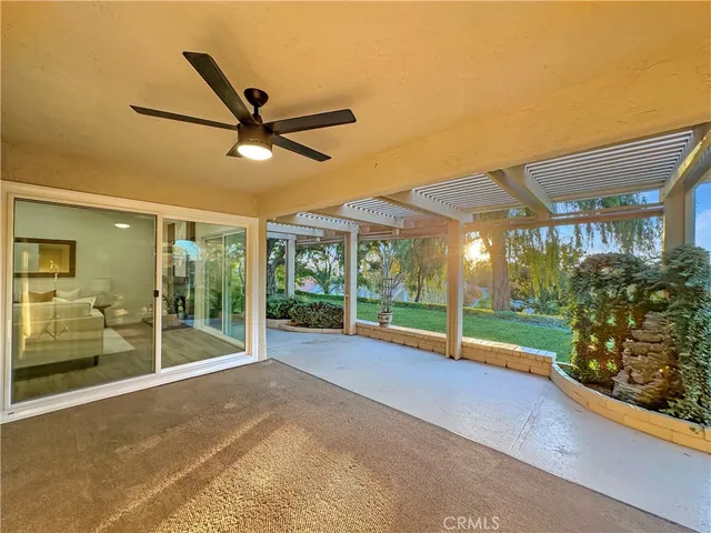 a view of a porch with furniture and garden