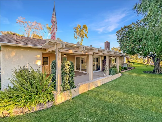 a view of a house with garden and deck