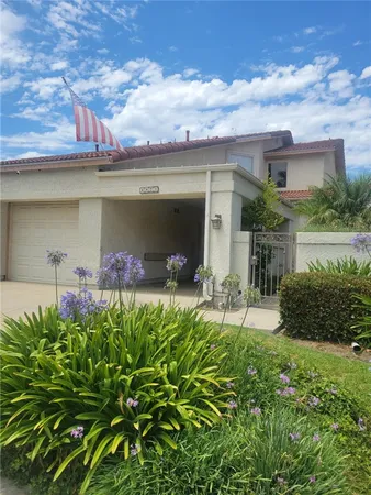 a view of a chair and table in the garden
