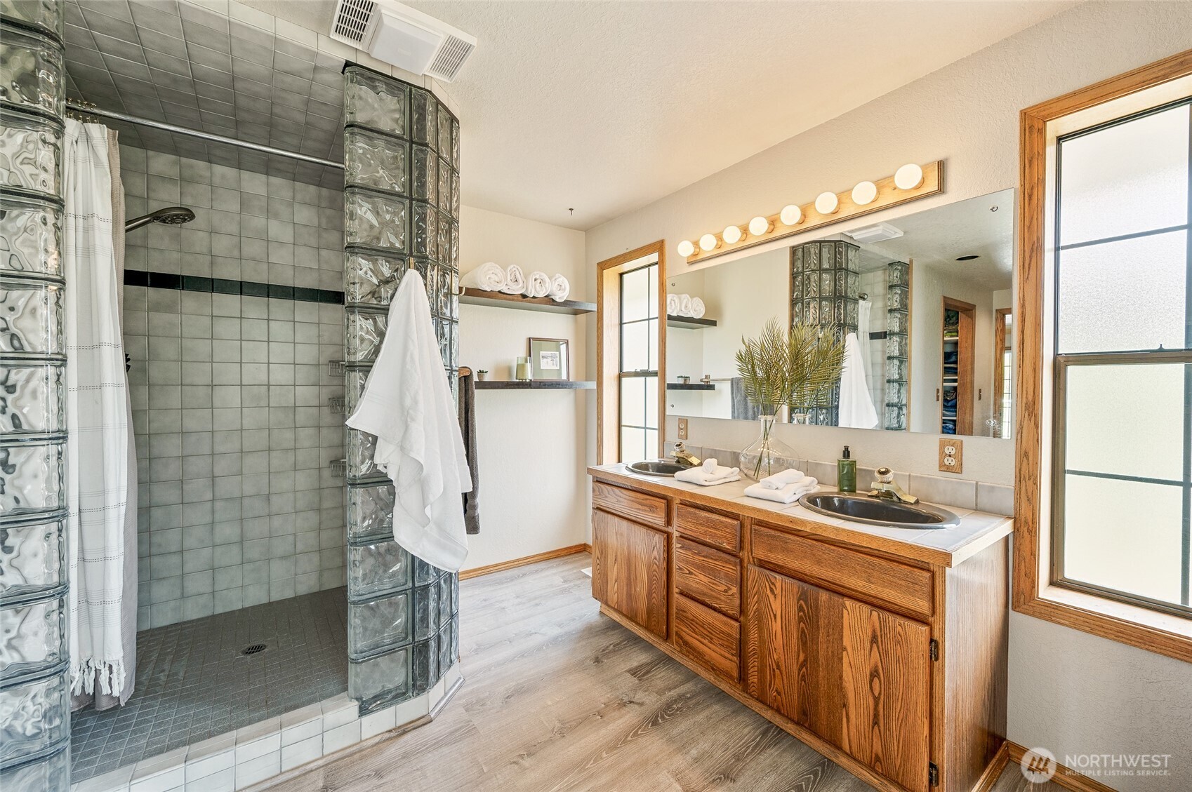 9656 North Road Peshastin, WA 98847 - Photo 21 of 40 a bathroom with a double vanity sink a mirror and a shower