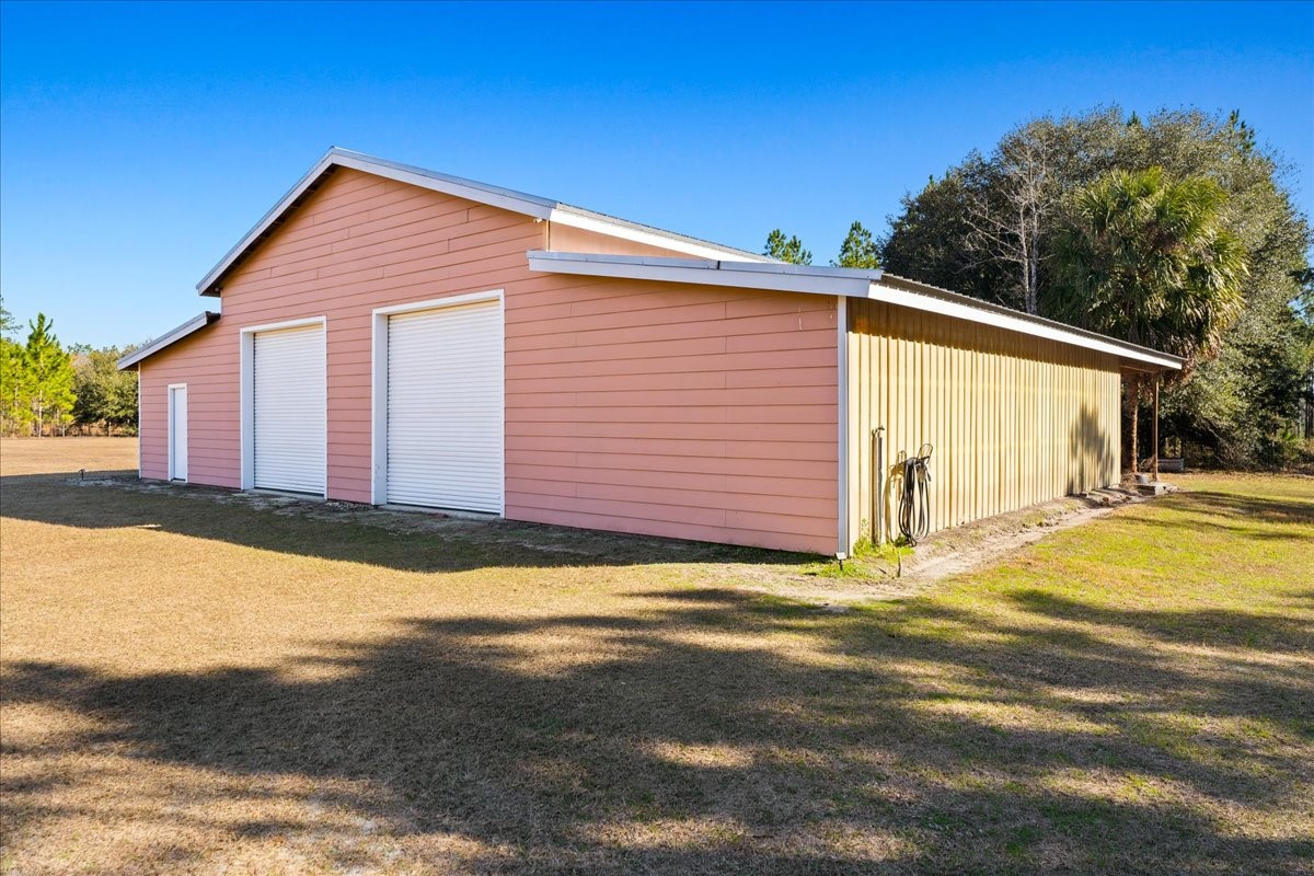 27247 Hallman Road Hilliard, FL 32046 - Photo 13 of 59 a view of yellow house with a yard