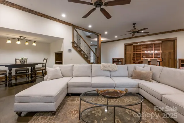 a living room with furniture and kitchen view