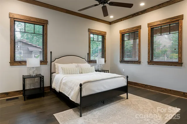 a bedroom with a bed ceiling fan and window