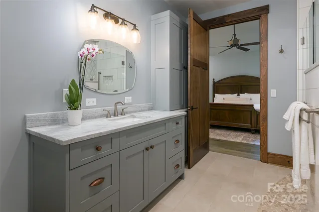 a bedroom with a bed next to a window