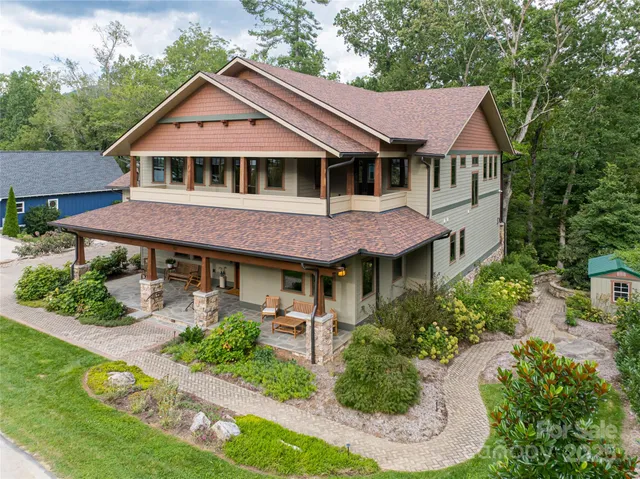 an aerial view of a house with a big yard