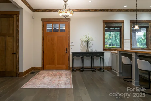 an empty room with a window and wooden floor