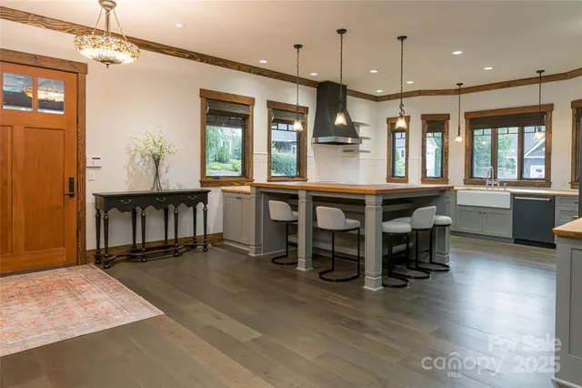a large kitchen with a table and chairs