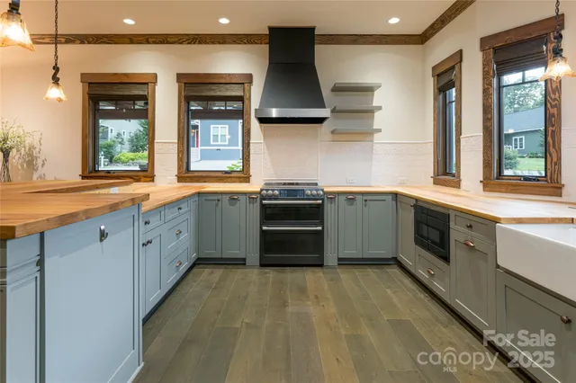 a kitchen with stainless steel appliances granite countertop a stove sink and window