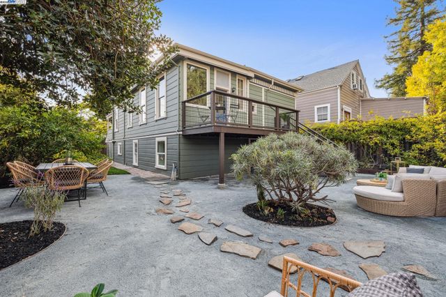 a front view of a house with a yard and fountain