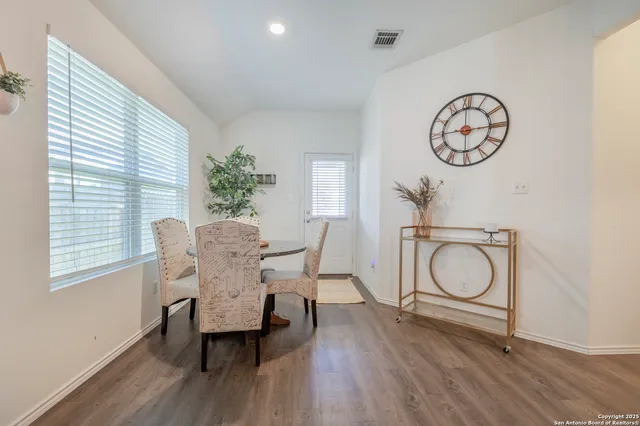 a view of a dining room with furniture and window