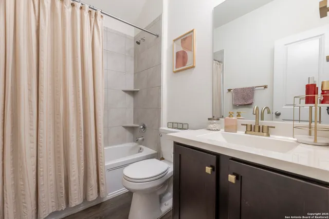 a bathroom with a bath tub sink shower and mirror
