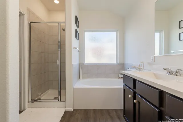 a bathroom with a tub sink and mirror