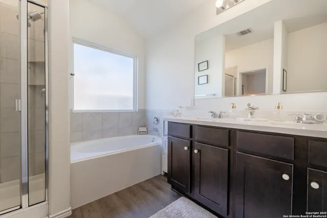 a bathroom with a sink vanity and a mirror