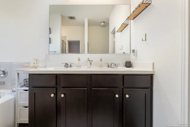 a bedroom with a bed and a mirror