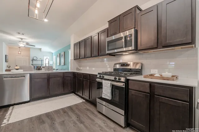a bathroom with a sink a mirror and cabinets