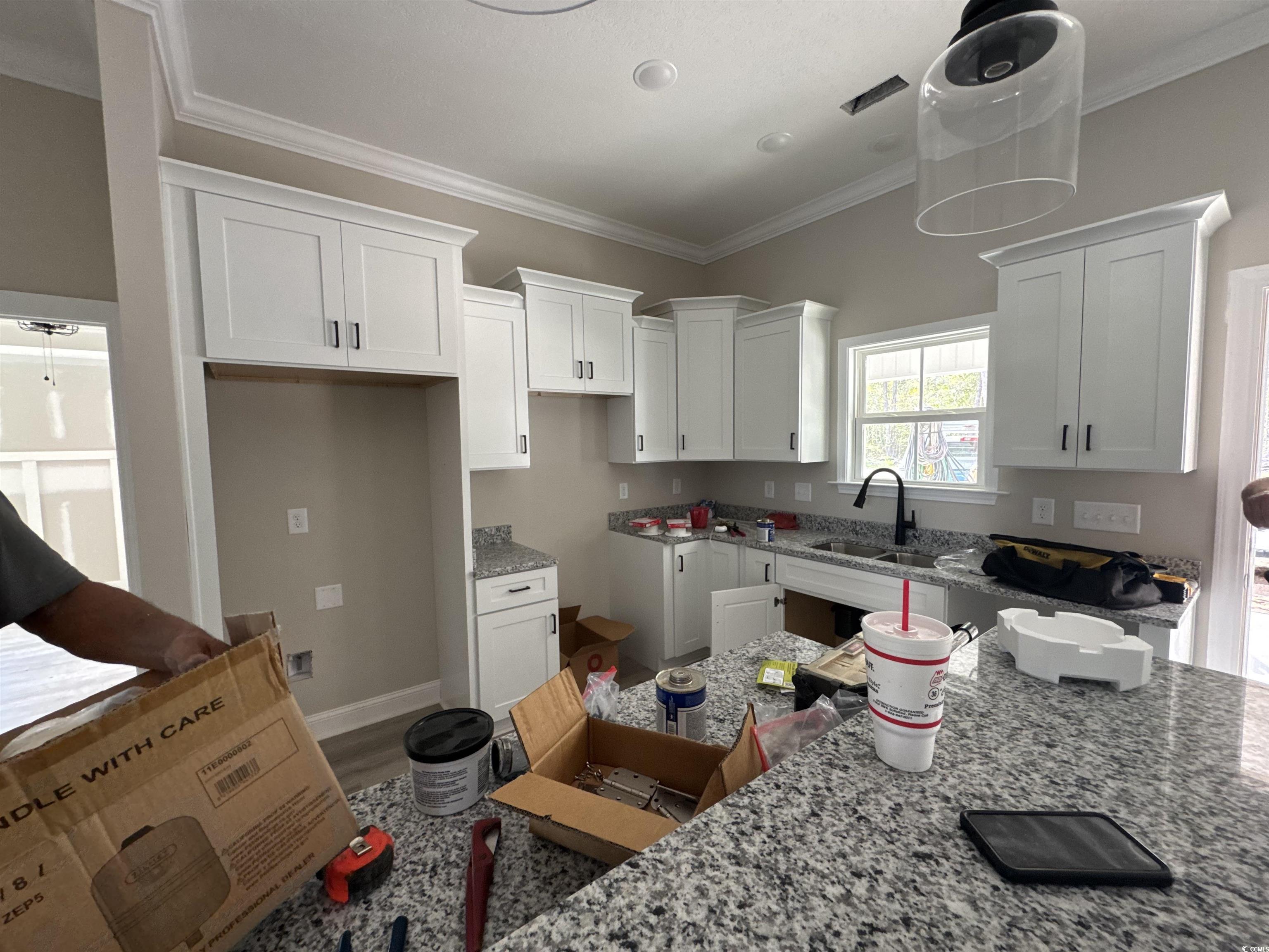 4020 Copperhead Road Conway, SC 29527 - Photo 6 of 16 Kitchen featuring crown molding, white cabinets, a