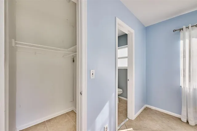 a view of a hallway with wooden shelves