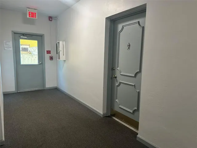 a large white kitchen with a sink and dishwasher a refrigerator with white cabinets