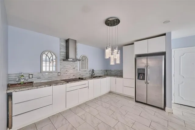a view of kitchen with granite countertop cabinets and white appliances