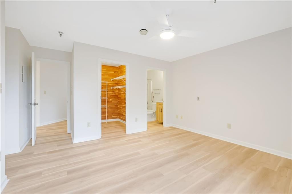 300 Johnson Ferry Road, Unit B103 Atlanta, GA 30328 - Photo 22 of 40 a view of an empty room with wooden floor and a window
