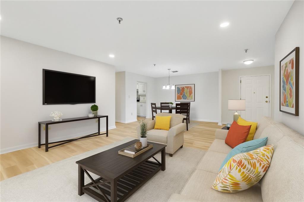 300 Johnson Ferry Road, Unit B103 Atlanta, GA 30328 - Photo 3 of 40 a living room with furniture and a flat screen tv