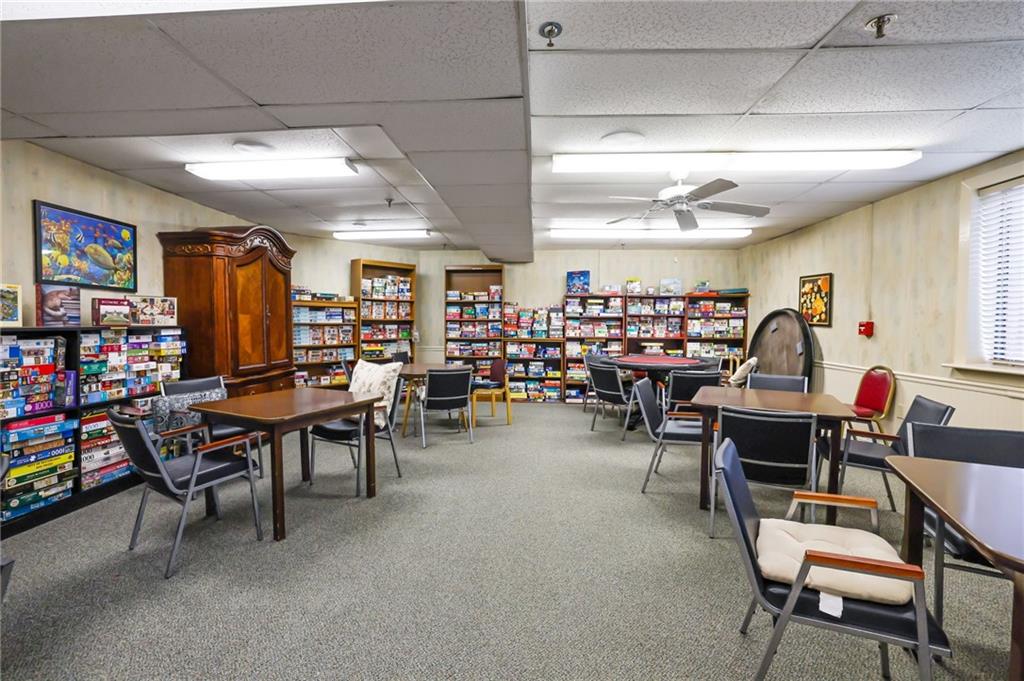 300 Johnson Ferry Road, Unit B103 Atlanta, GA 30328 - Photo 32 of 40 a living room with lots of furniture and a flat screen tv