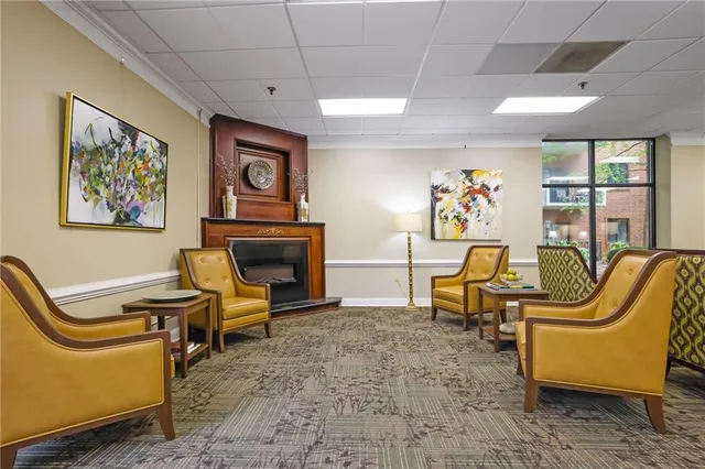 a living room with furniture a piano and a fireplace