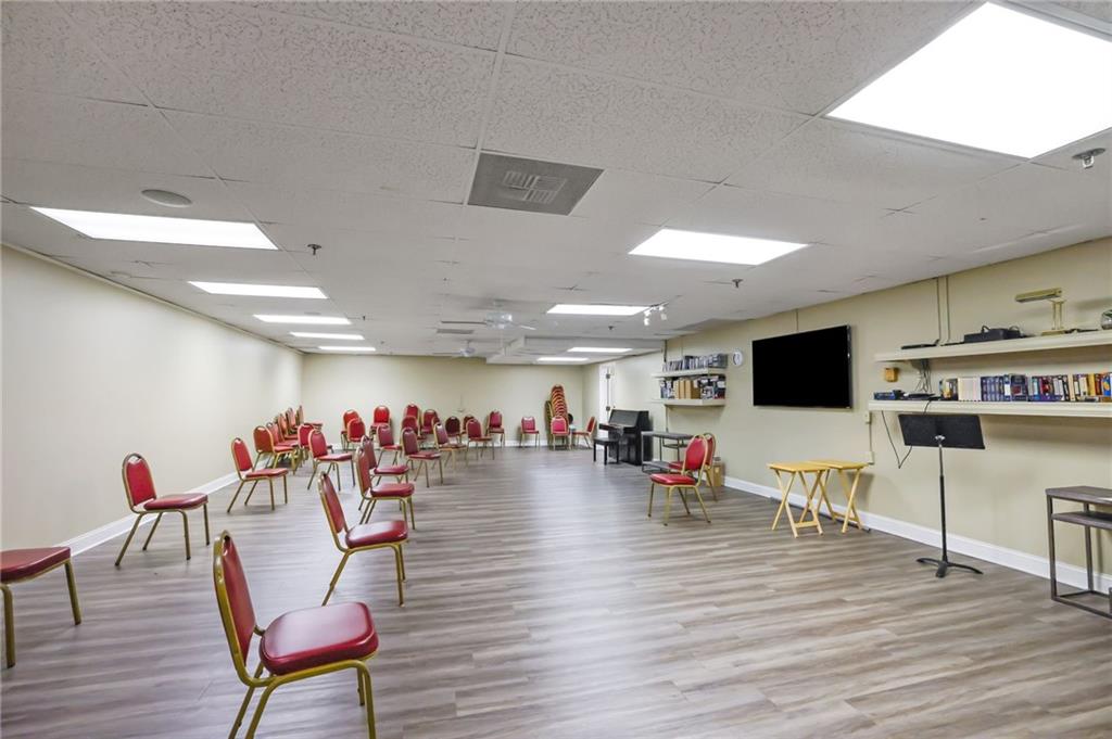 300 Johnson Ferry Road, Unit B103 Atlanta, GA 30328 - Photo 37 of 40 a living room with lots of furniture and a flat screen tv