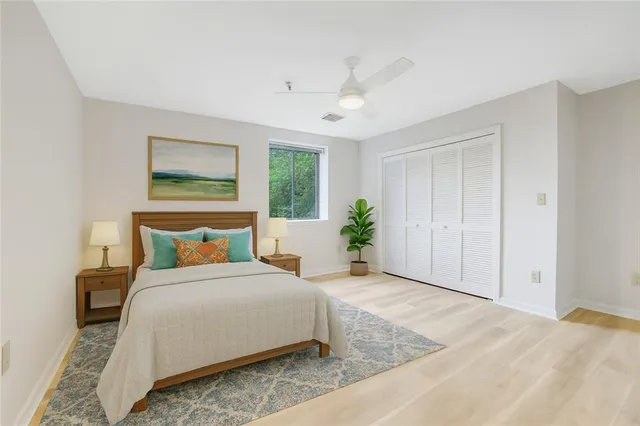 a bedroom with a bed table and a window