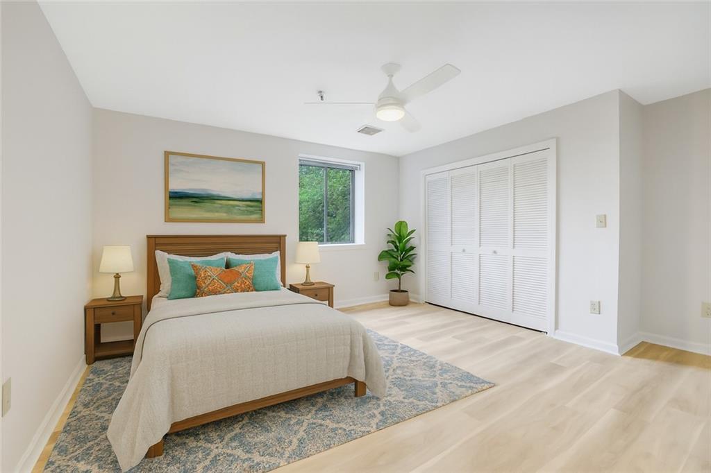 300 Johnson Ferry Road, Unit B103 Atlanta, GA 30328 - Photo 8 of 40 a bedroom with a bed table and a window