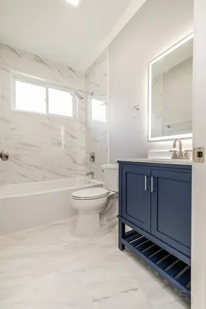 a bathroom with a toilet a sink and bathtub