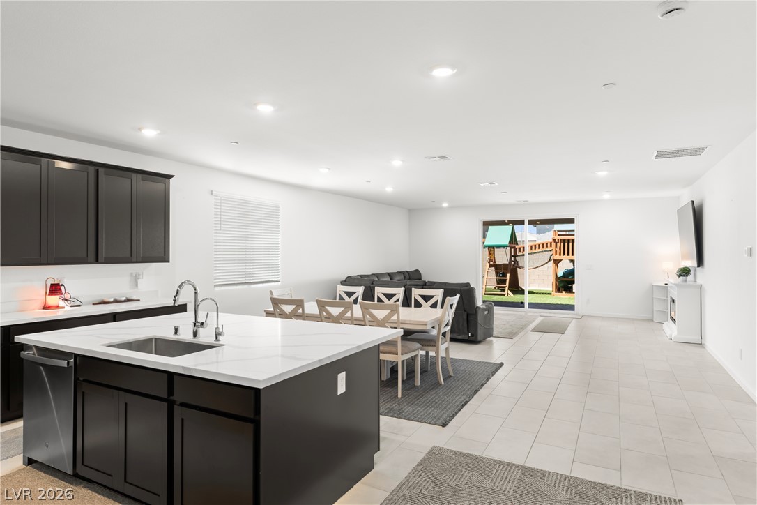 320 Isla Enclave Way Henderson, NV 89011 - Photo 4 of 49 This open-concept living space boasts a functional kitchen island and seamless access to the outdoors.